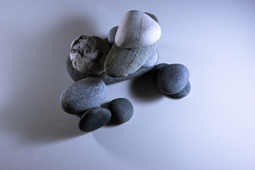 gray white and black sea pebbles on a white background