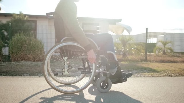 Morning outing of disabled man in wheelchair