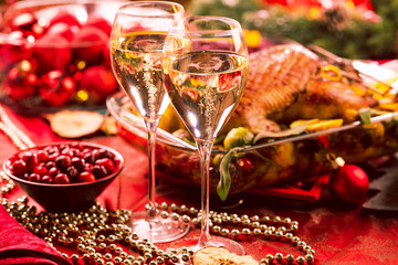 Fototapeta na wymiar Christmas themed dinner table with christmas duck and champagner 