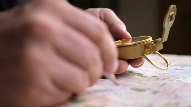 Travel Destination Points on Map with Compass in Hand on Background of Map. Finding Your Way Concept