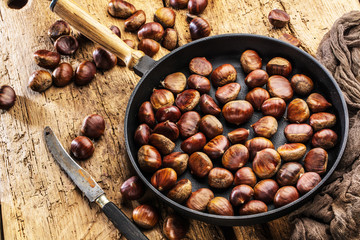 Roasted chestnuts served on an old table