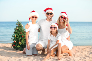 Happy family celebrating Christmas at tropical resort