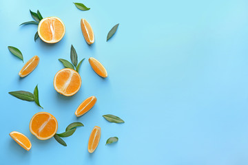 Ripe cut oranges on color background