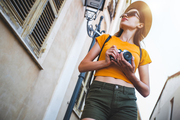 Female blogger travelling Italy with retro camera