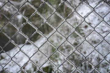 Wide Shot of Ice on Chain Link
