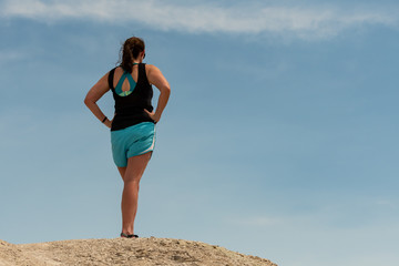 Woman Looks Out Over Landscape with Copy Space