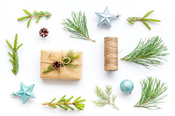 Winter festive layout with spruce branches and New Year presents on white background top view flat lay
