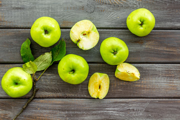 Autumn composition with green apple on dark wooden background top view copy space