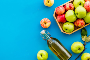 Vinegar made from fresh apple on blue background top view copy space