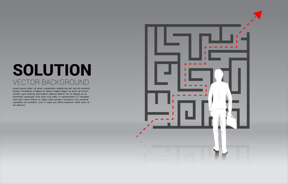 Silhouette of Businessman standing with plan to exit from maze . Business concept for problem solving and solution strategy. 