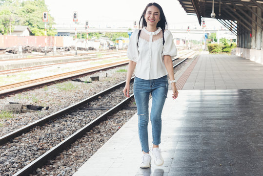 Asian traveler woman wait train at railway station.Travel holiday,relaxation concept.