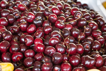 A background of sweet cherries on display at a local farmers market.