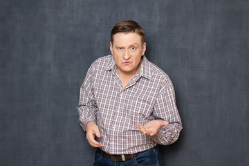 Portrait of angry dissatisfied annoyed man turning to you