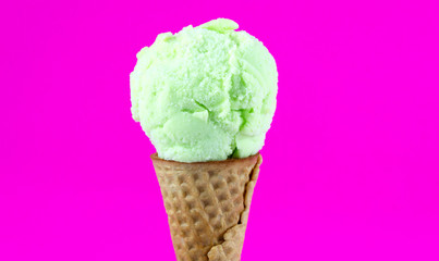 ice cream lemon scoop in waffle cone isolated on pink background, Closeup Front view Food concept..