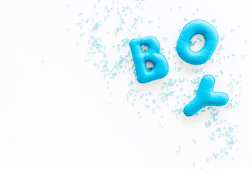 Boy word as decoration for baby shower on white background top view copy space