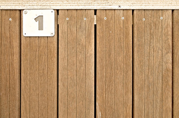 1, number one, metal plate on wooden teak deck.