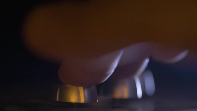 The hand of an audio engineer is moving a controller on the mixing cosole. This is a professional studio equipment.