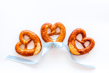 Octoberfest symbol. Fresh bavarian pretzels on white background top view space for text