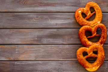 Pretzels frame, dark wooden background top view space for text