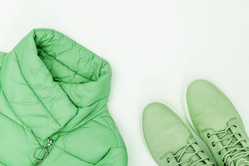 Bright fashion clothes trend color on white background with copy space. Warm down jacket and...