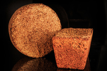 closeup round and rectangular rye bread with sesame seeds