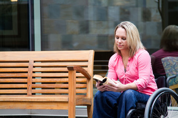 Beautiful Woman in Wheelchair Reading a Book
