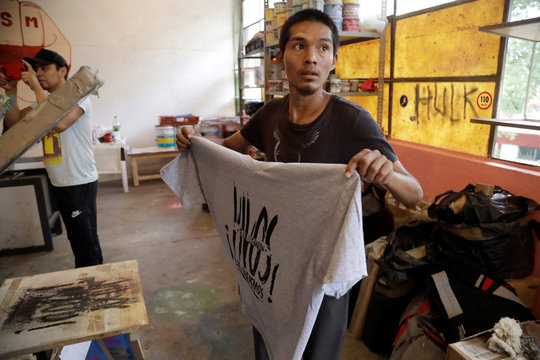 A student of Ayotzinapa Teachers Training College "Raul Isidro Burgos" works at a serigraph workshop before the fifth anniversary of the disappearance of 43 students from the college in Tixtla