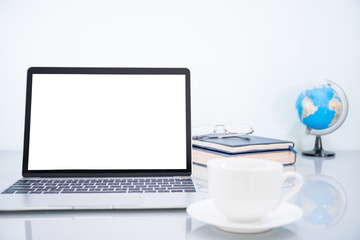Laptop mockup and coffee cup on table
