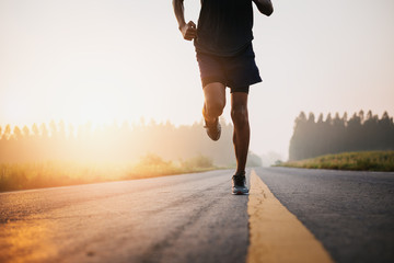 Athlete runner feet running on road, Jogging at outdoors. Man running for exercise.Sports and...