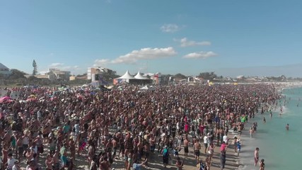 Drone shot, WSL surf championship, crowd at the beach, Saquarema Brazil. - Powered by Adobe