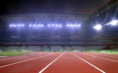 Papier Peint photo Chemin de fer Running track in a stadium under bright spotlights