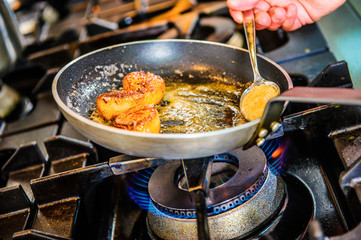 Chef decorating sweets at kitchen. Closeup male chef making dessert in motion. Professional cook decorating cake at workplace.