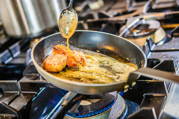 Chef decorating sweets at kitchen. Closeup male chef making dessert in motion. Professional cook decorating cake at workplace.