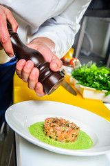 Salmon sashimi spicy salad cooking by cheef in the restaurant .