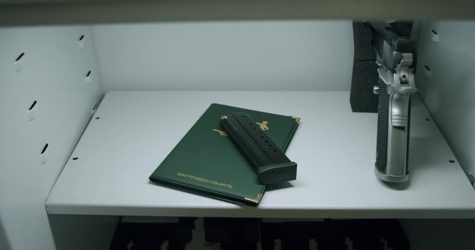 A weapons possession card and weapons in a gun safe.