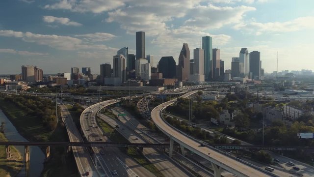 Aerial view of cars on freeway with downtown Houston in the background