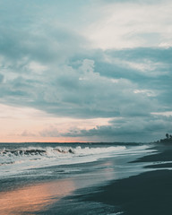 Fototapeta premium Wallpaper- Ocean sunset on black sand beach