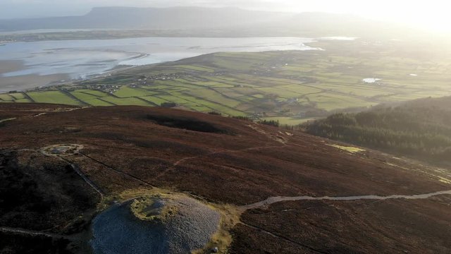 Fly over mountain to Irish countryside
