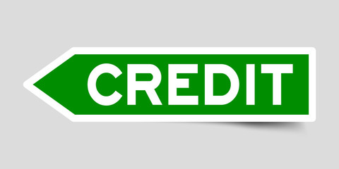 Label sticker in green color arrow shape as word credit on white background