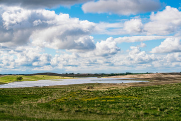 Fototapeta na wymiar A lake is Saskatchewan Canada beside a farm