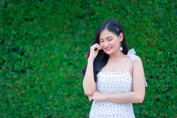Fototapeta premium Portrait of Beautiful young woman with summer green park background