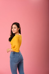 portrait of smiling asian woman in casual clothing. studio shot