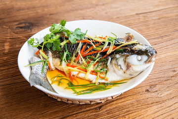 Chinese dish of steamed aconite on wooden table