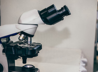 microscope for examining test sample in laboratory. blur background