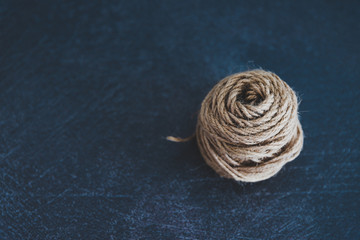 tangled ball of thread with string popping out of it