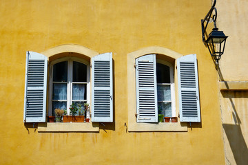 facade of mediterranean building with colorful shutter 