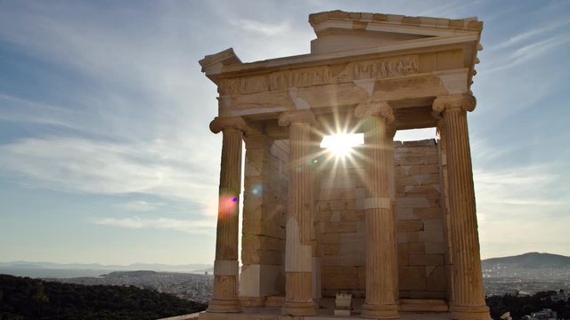 Time Lapse of the sun appearing behind the ancient temple of Athena Nike in the Acropolis in Athens, Greece