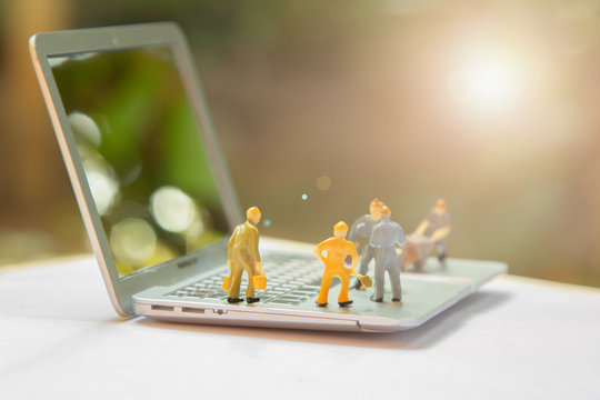 Miniature worker people or small figure cleaning computer maintenance model as electronic repair and technology development concept. Cleaning team work on engineer fixing broken computer motherboard. - Powered by Adobe