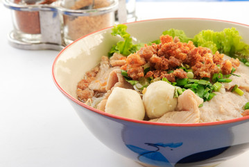 Thai Noodles​ with pig machine and meat ball and fresh vegetables and warm soup on white background