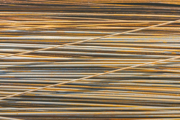 Background texture of old rusty steel bars construction materials in a construction site